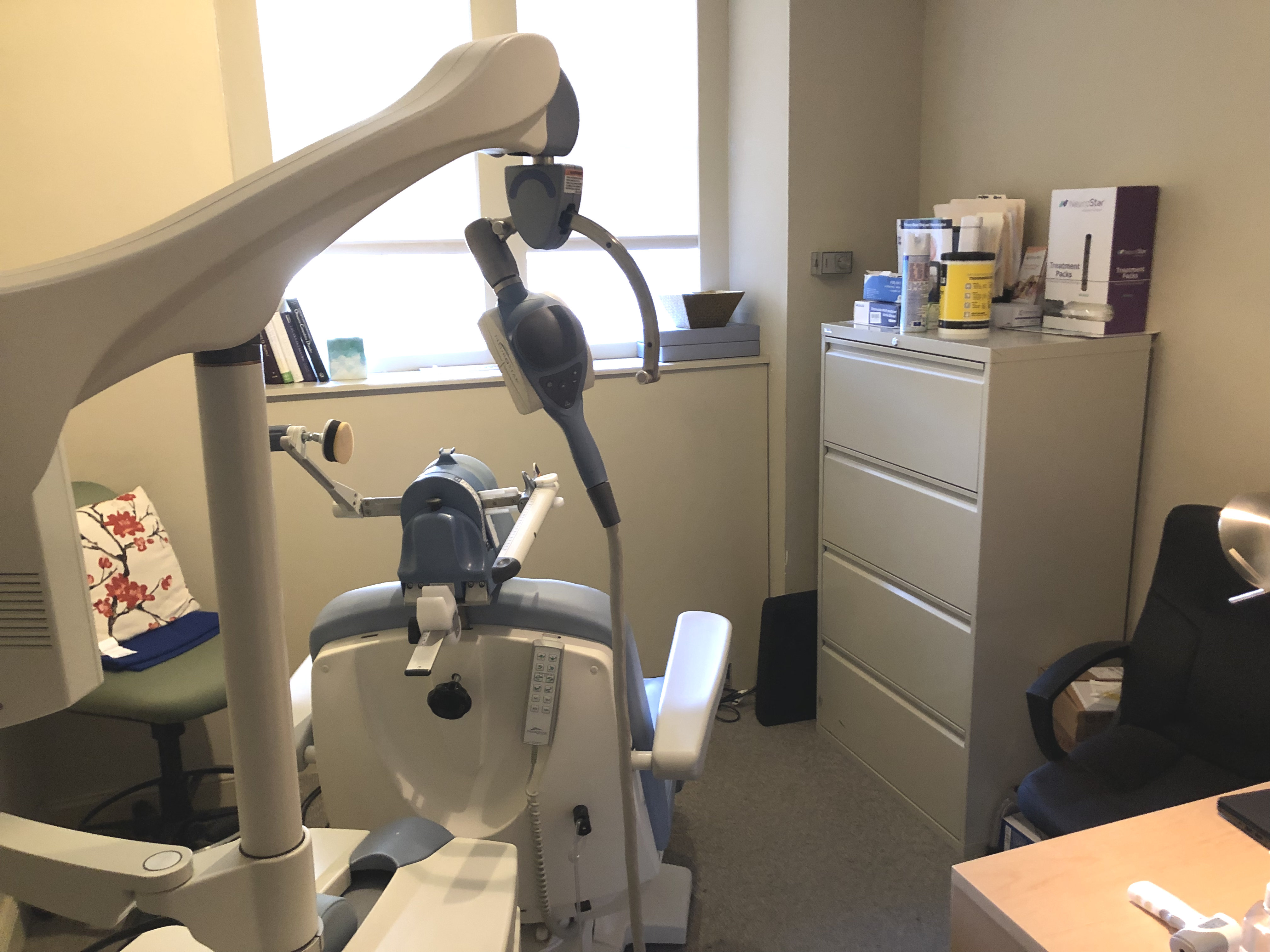 Office interior featuring desk, chair, and electronics